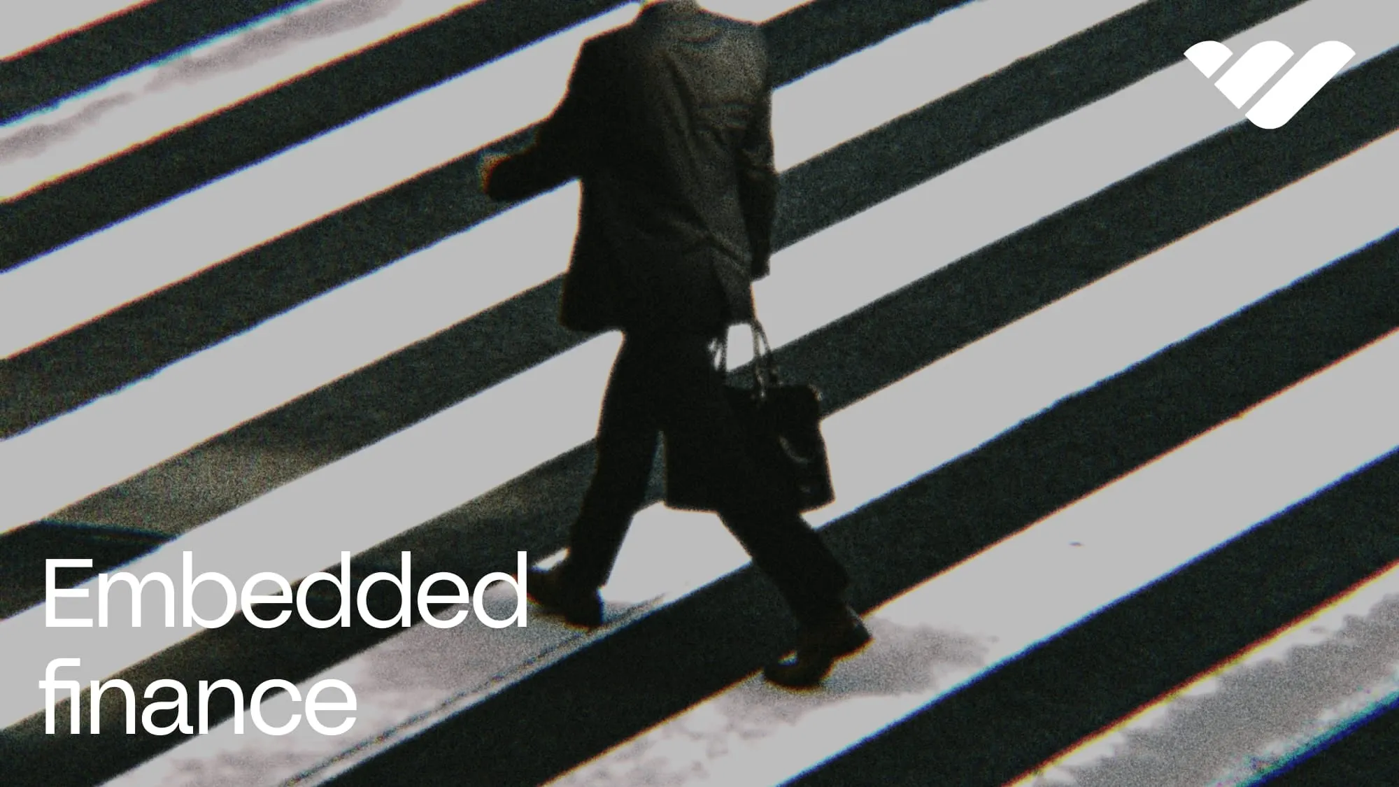 embedded finance companies blog cover (person in suit with briefcase walking across zebra crossing)