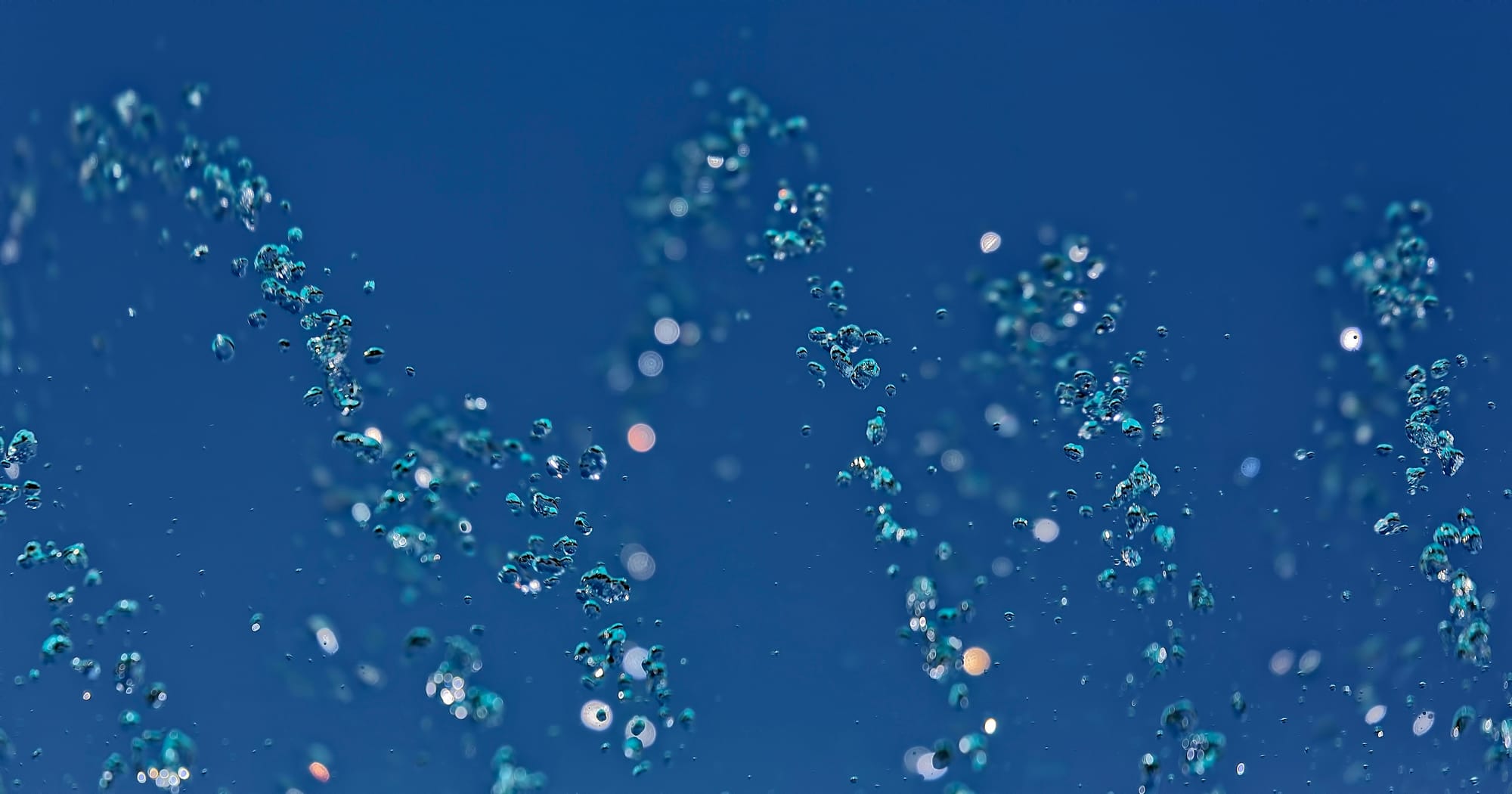An abstract, closeup image of water bubbles under water