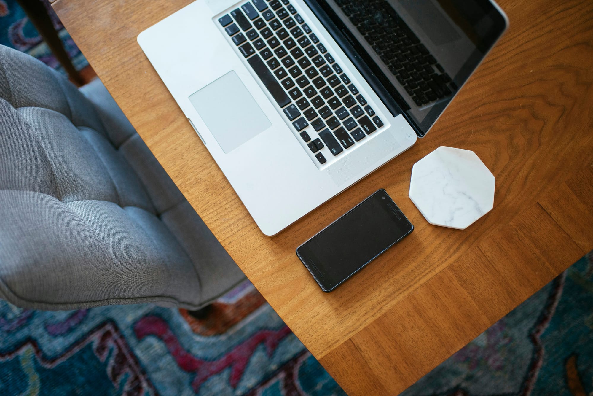 Image of a laptop and cell phone on a table