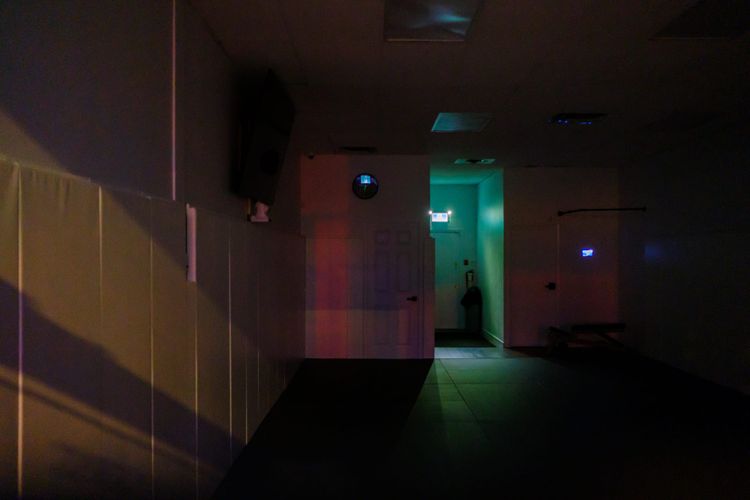 Colours of my city in a vacant retail space after dark – gold, red, purple, green, and blue; East Van, Vancouver