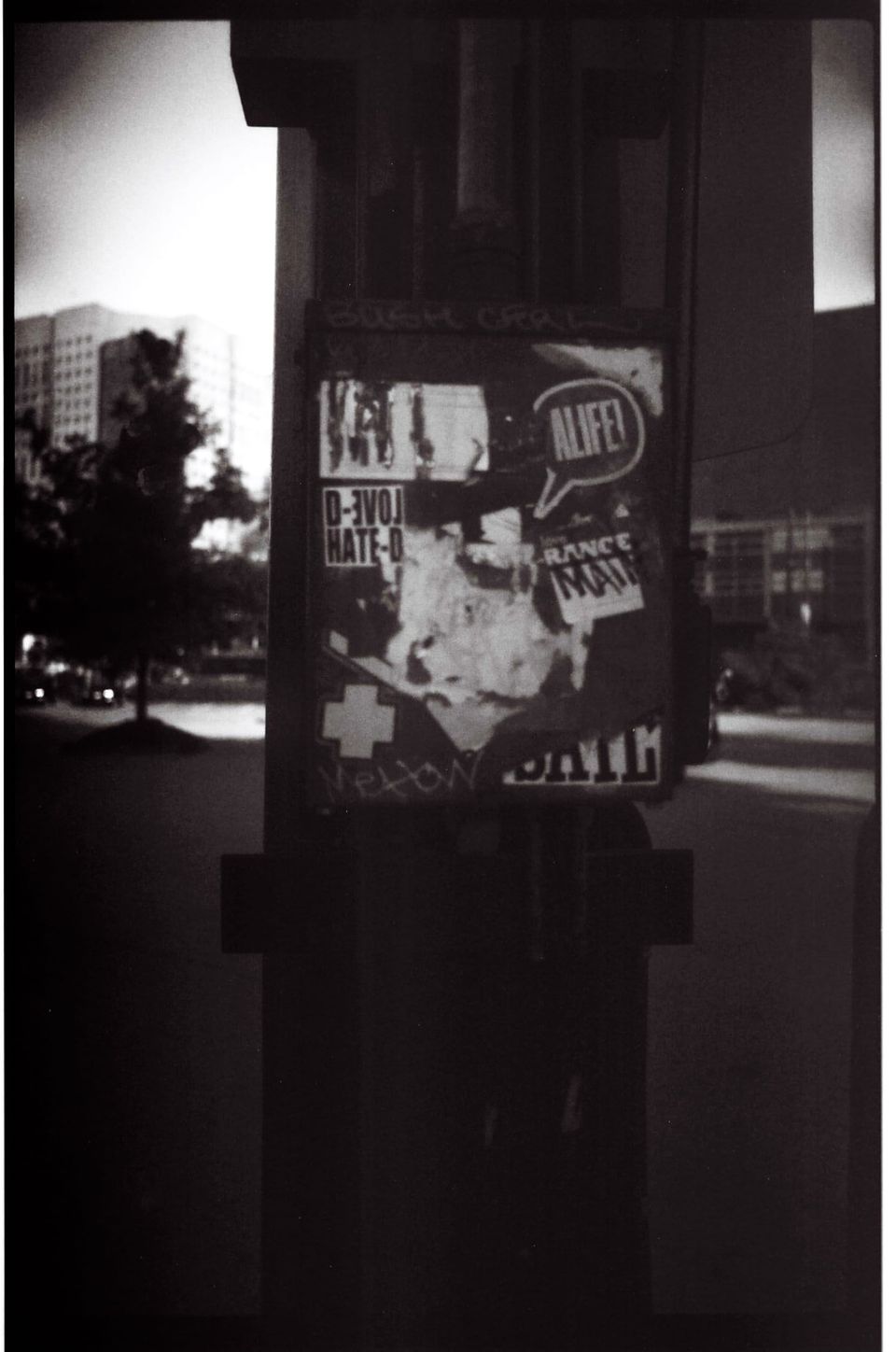 Stickers and billets on a post in an open air parking lot; near Stadium Station, Crosstown, Vancouver