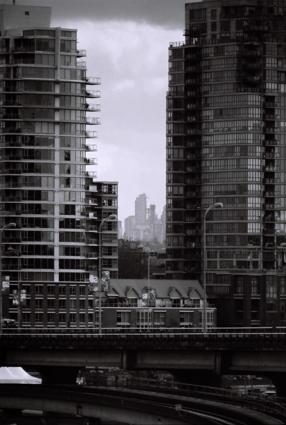 Looking east from Dunsmuir Viaduct between the towers of Main St. to the towers in Metrotown, Burnaby