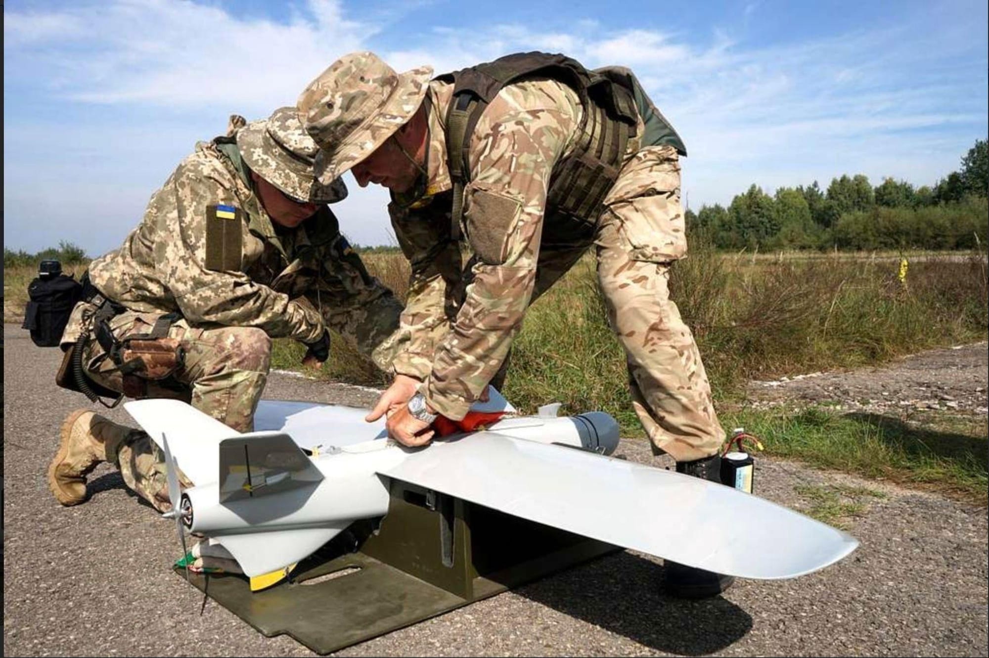 Ukrainian soldiers pack up a drone