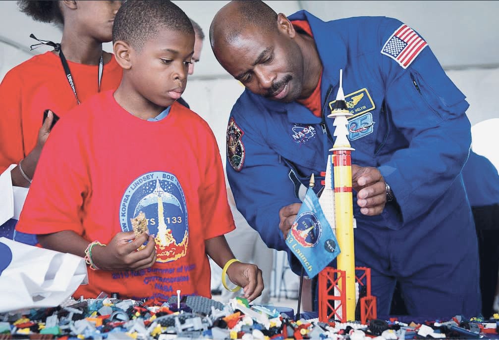 Astronaut Leland Melvin talks with school children
