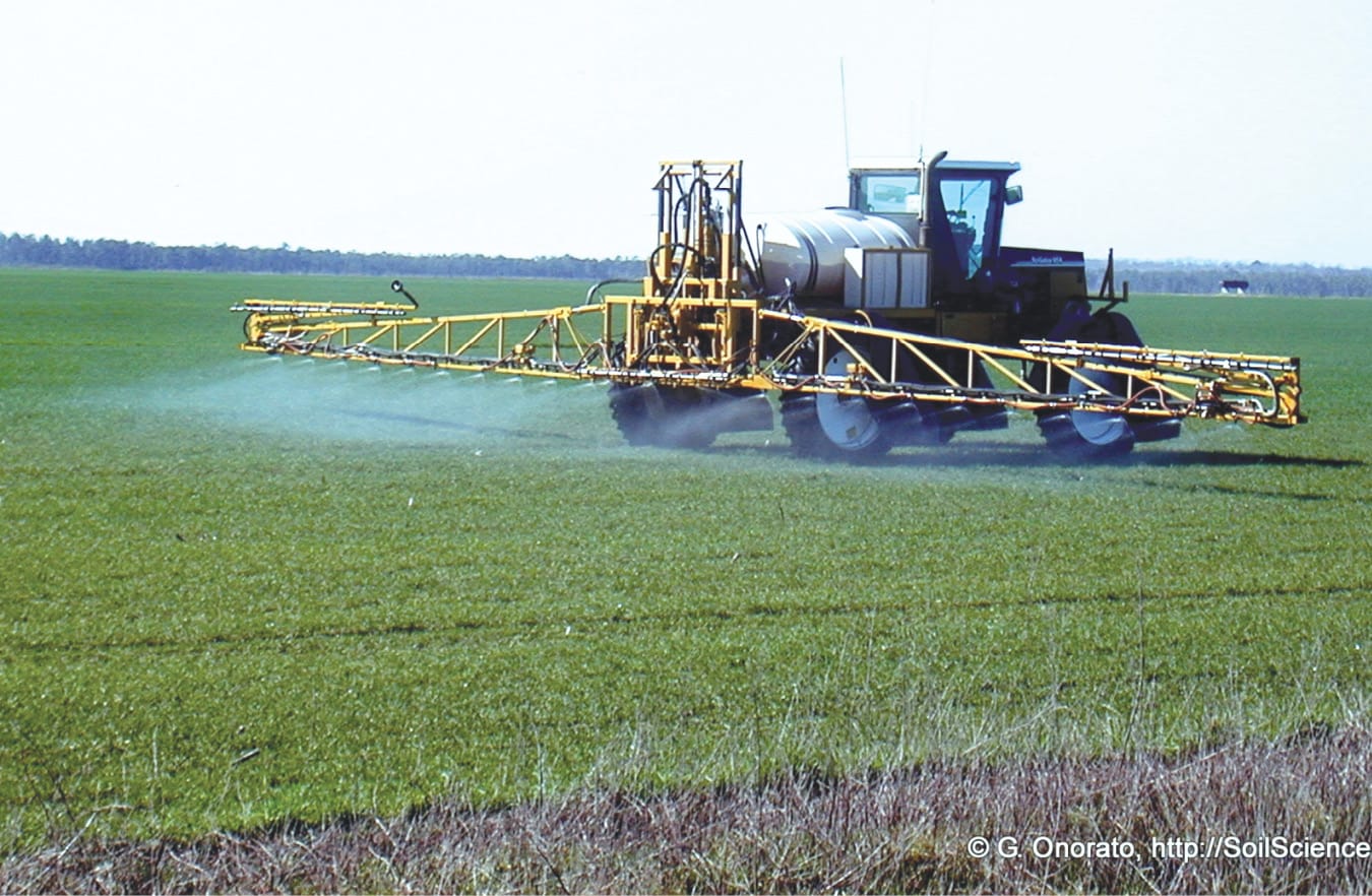 A fertilizer spreader in a field