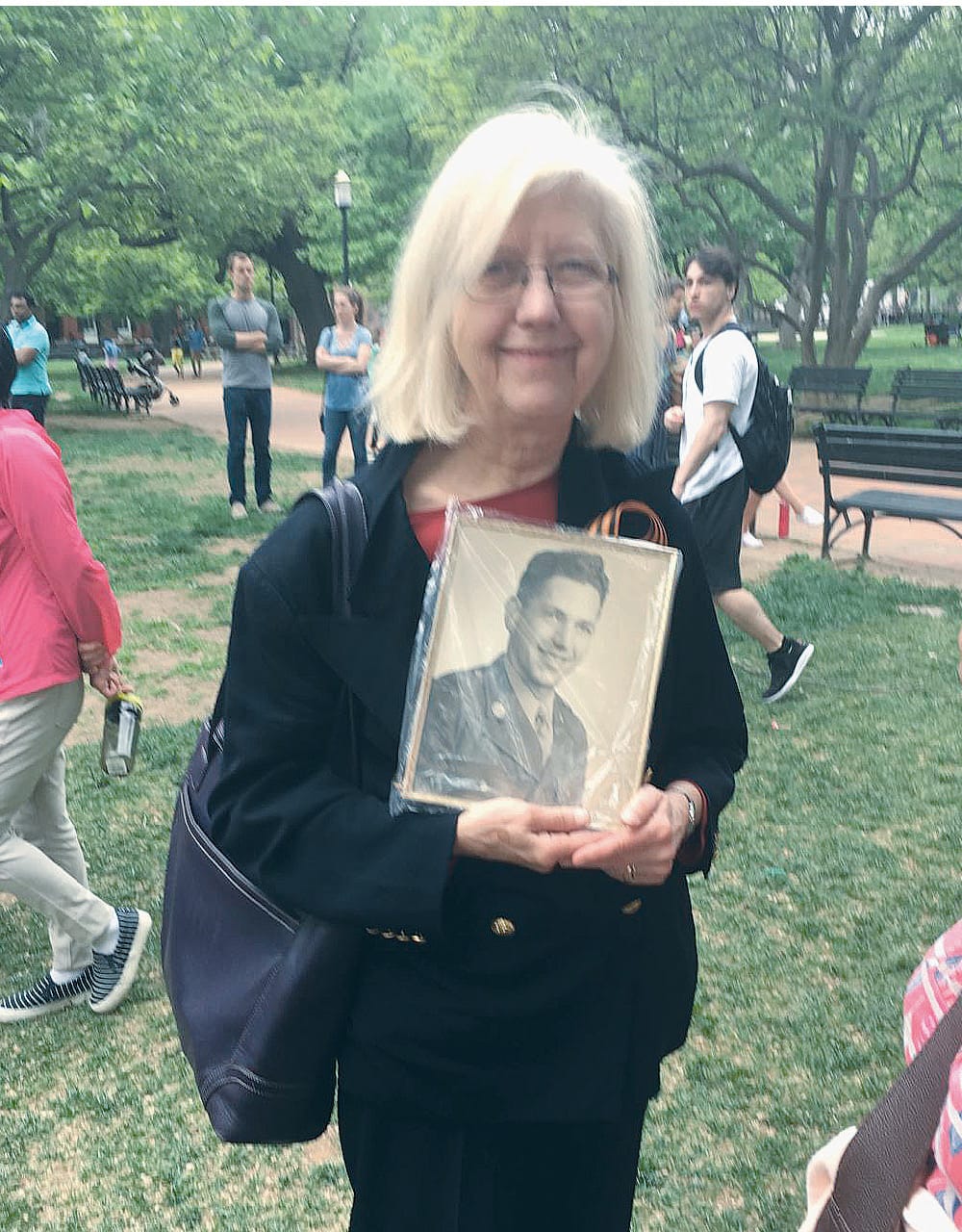 Anita Gallagher at a May 5, 2018, Immortal Regiment march in Washington D.C. She holds a picture of her father, who served in the U.S. Army during World War II.