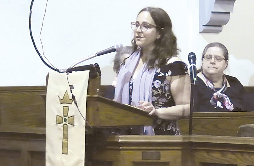 Choral Director Jen Pearl delivering introductory remarks