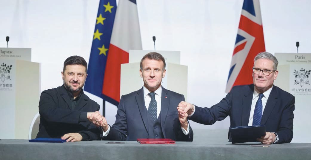 (Left to right) Ukrainian Acting President Volodymyr Zelensky, French President Emmanuel Macron and British Prime Minister Keir Starmer shake hands during the signing of a declaration during the Coalition of the Willing summit on security guarantees for Ukraine in Paris, January 6, 2026.