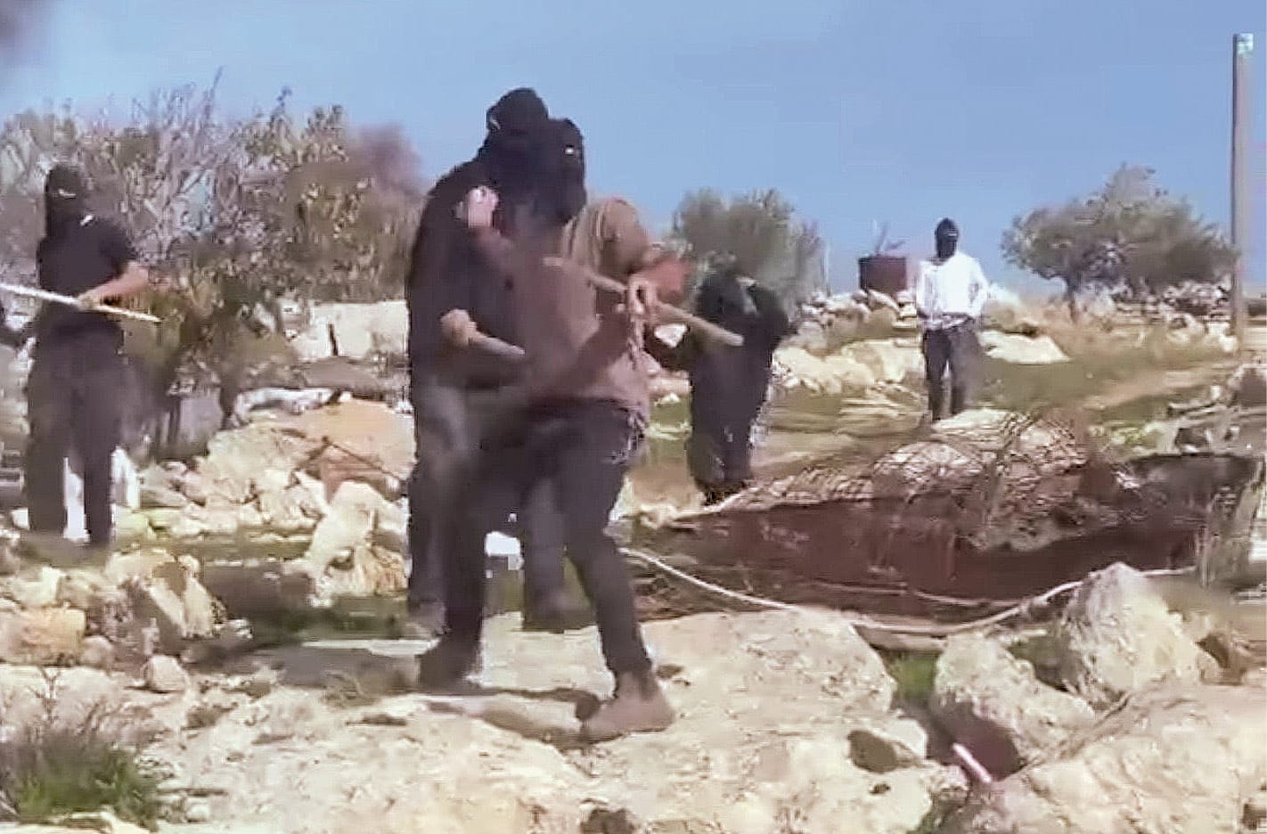 Israeli settlers from the "Hilltop Youth" throwing stones at reformist rabbi Arik Ascherman, in the occupied West Bank, December 21, 2025.