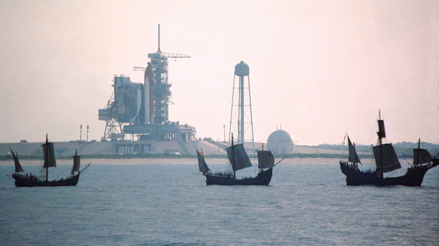 Sail on, Columbus! Replicas of the Santa Maria, Niña, and Pinta sail near the Space Shuttle Endeavour, as it awaits liftoff in May 1992.