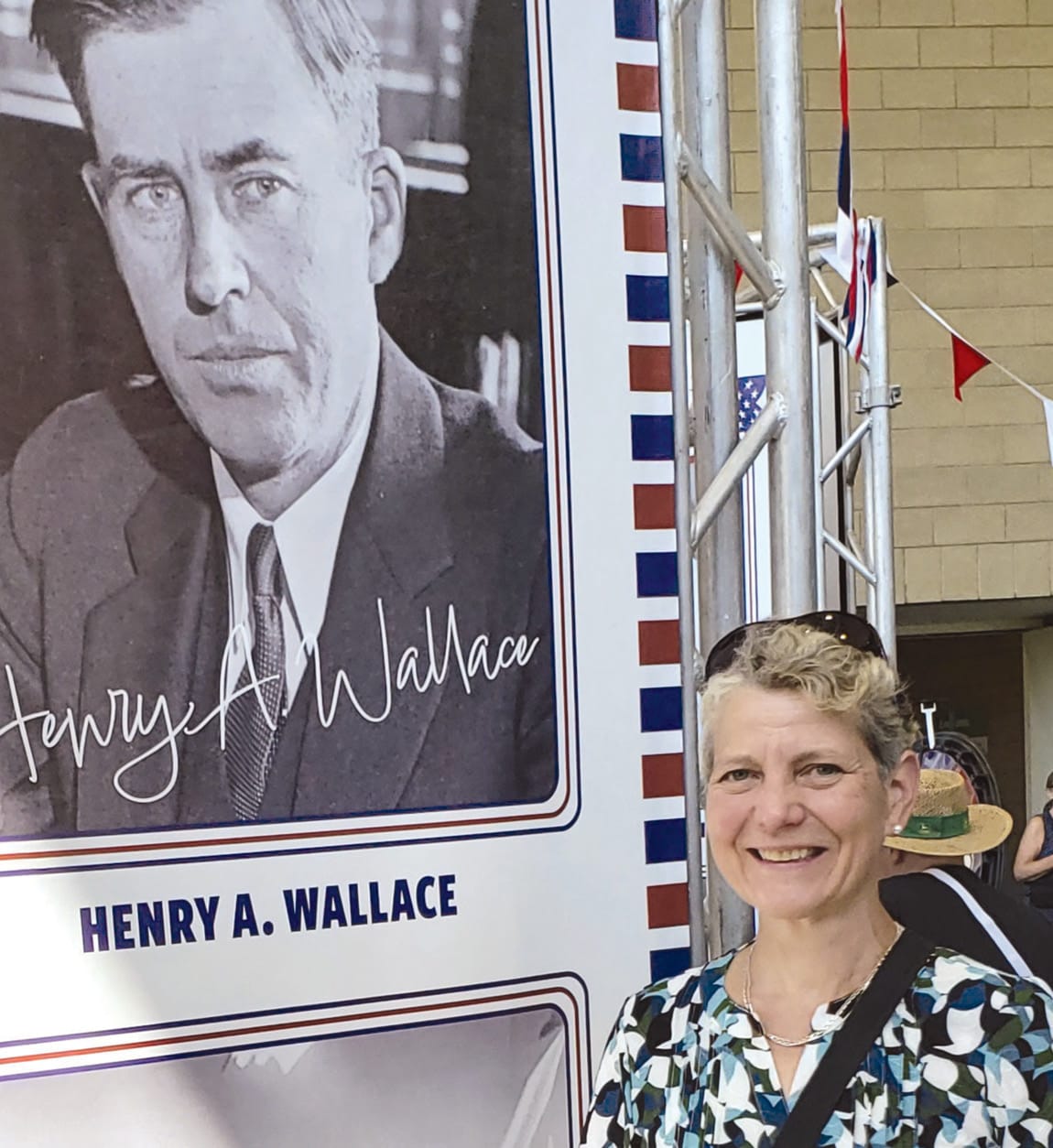 Sare at a banner for Henry A. Wallace (1888-1965), at the Iowa State Fair in Des Moines.