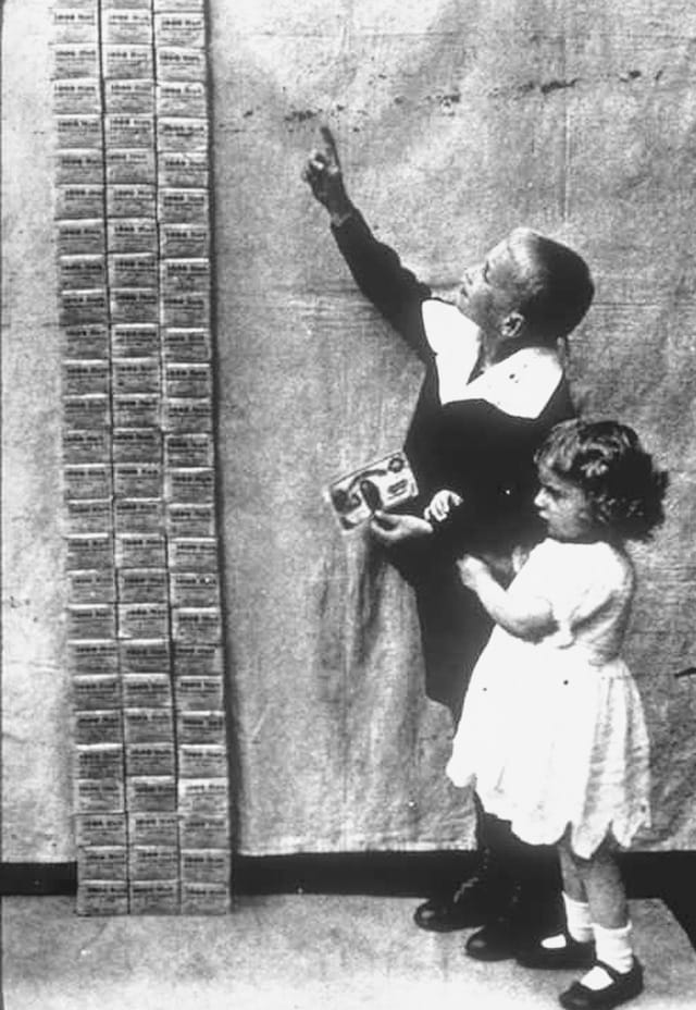 German children using a stack of hyperinflated marks as toy building blocks, 1923.