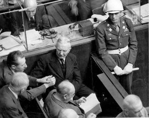 Dr. Hjalmar Schacht seated in the dock at the Nuremberg War Crimes Trials in 1946.