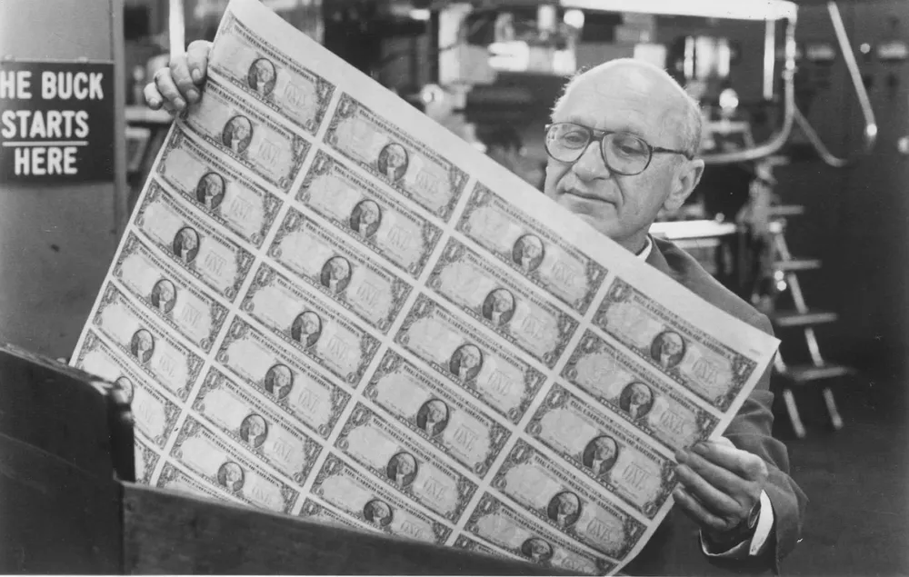 Nazi economist Milton Friedman gazes lustfully at newly printed dollars. This was apparently the closest he came to experiencing love.