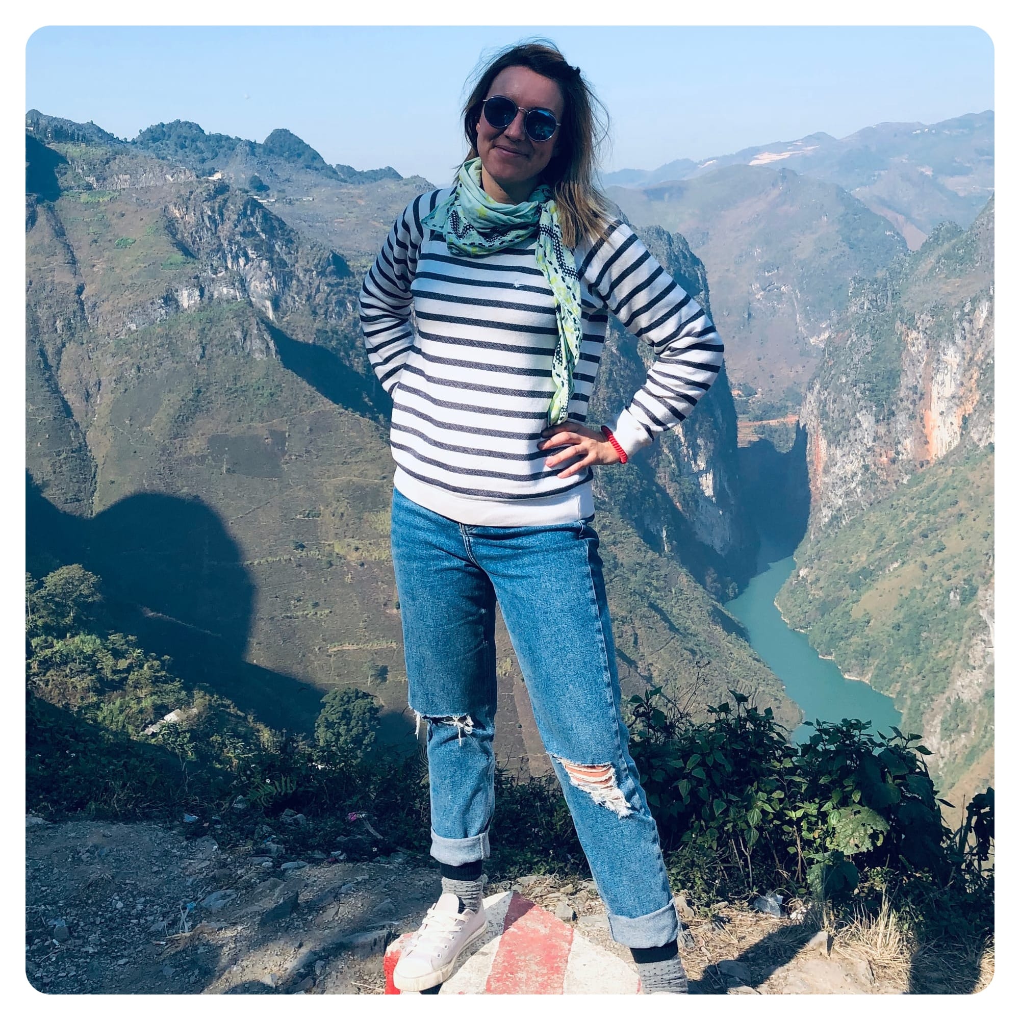vanlavita woman posing on cliffside at Ha Giang Loop Viertnam