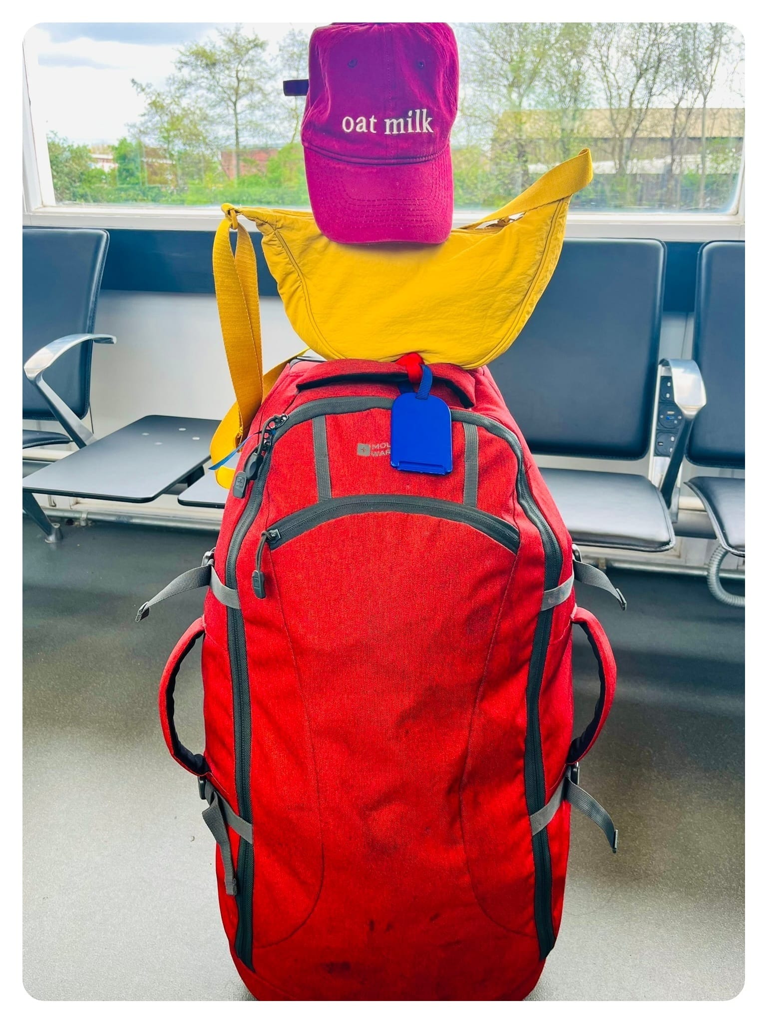 vanlavita red rucksack, yellow bag and burgundy baseball cap 