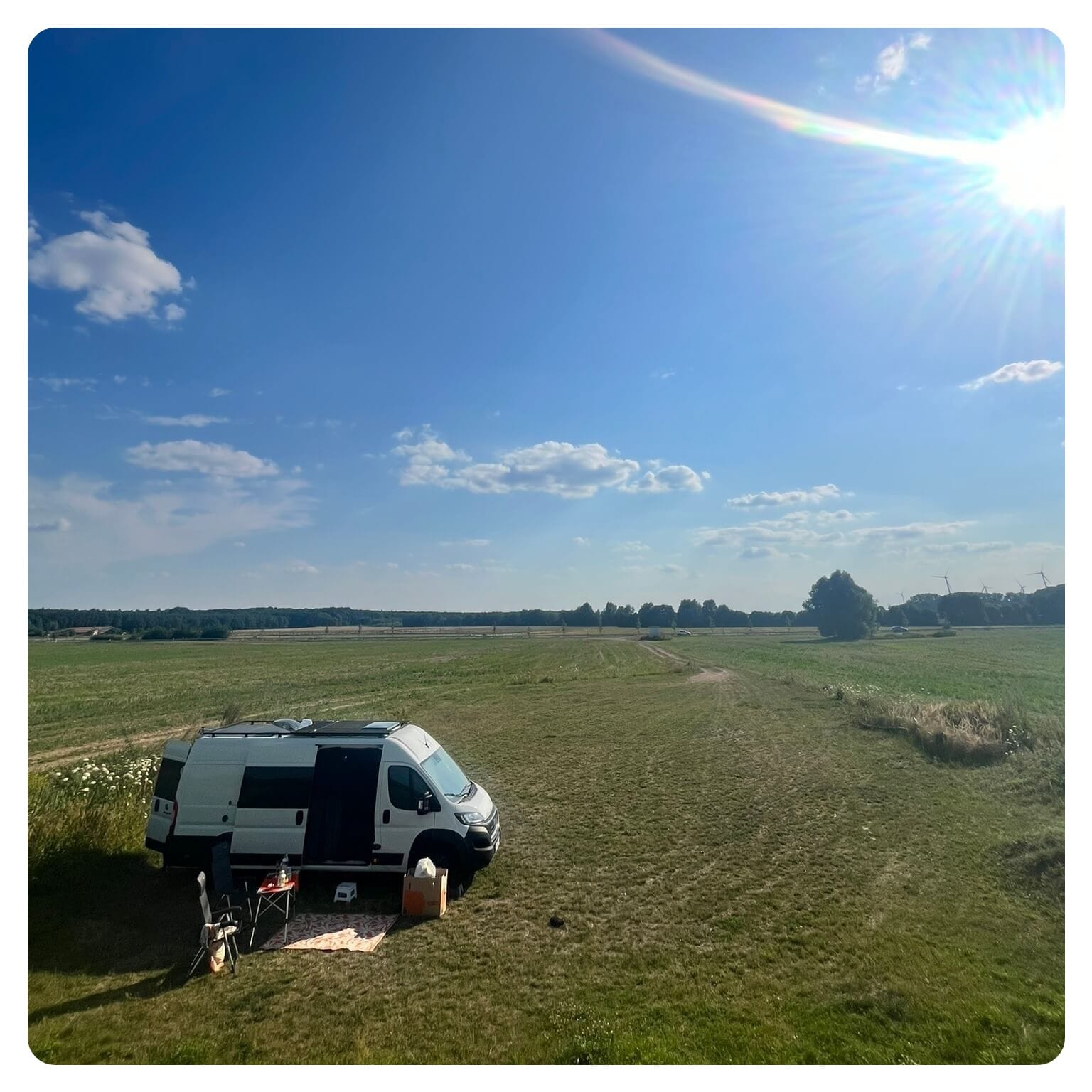 Van life camper van in open green field in Germany