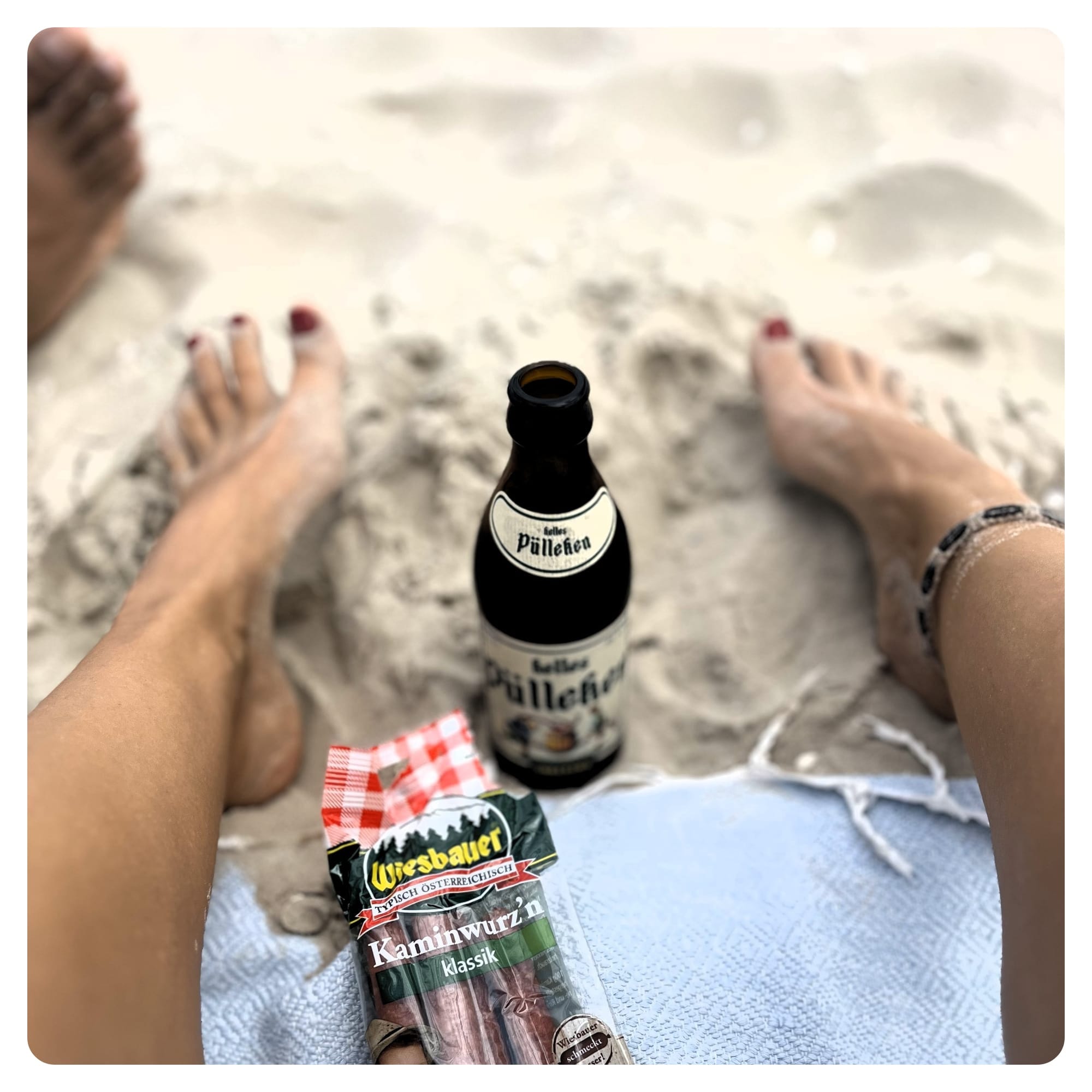 van life vanlavita feet in beach sand with bottle of German beer and sausages