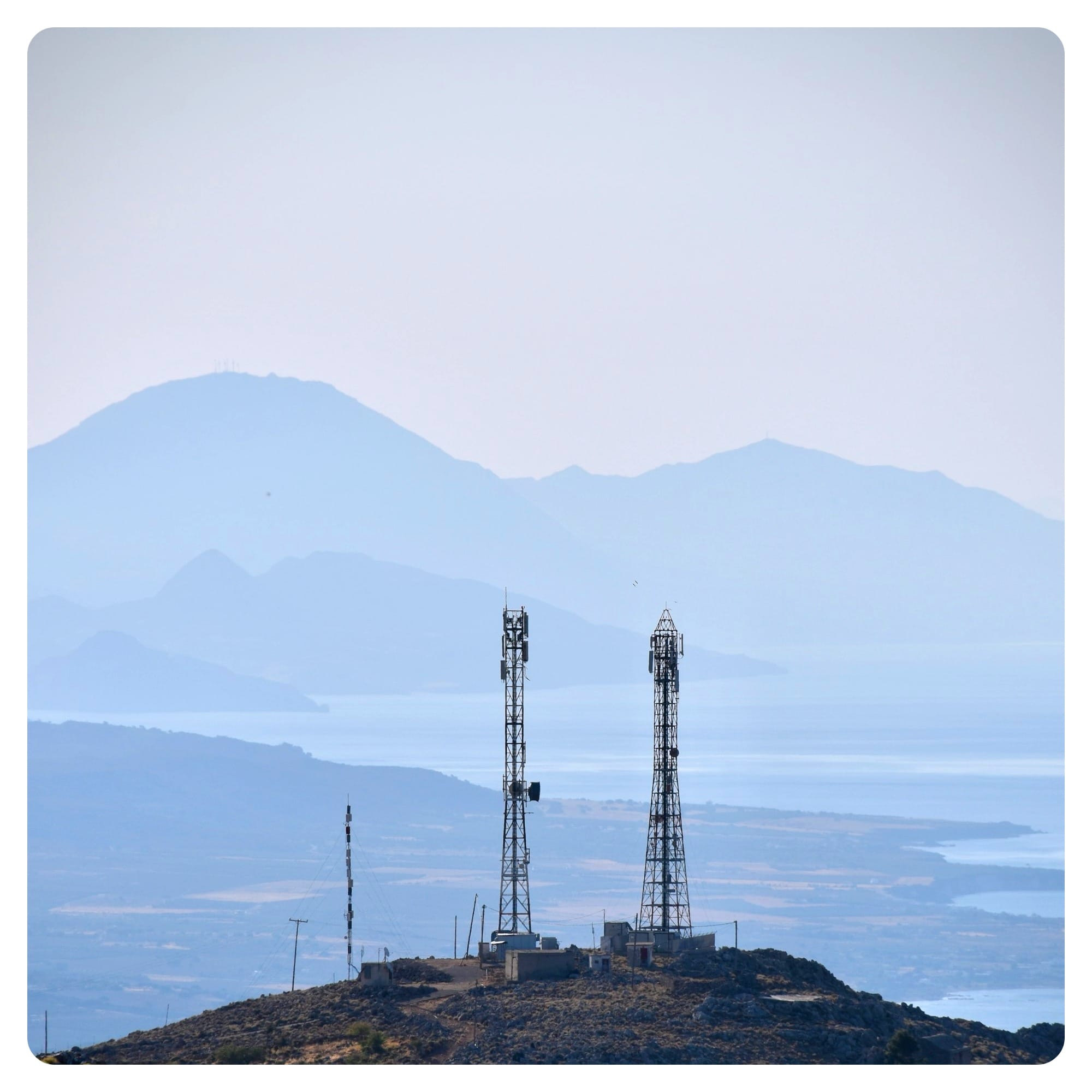 a group of mobile connection towers on a hill