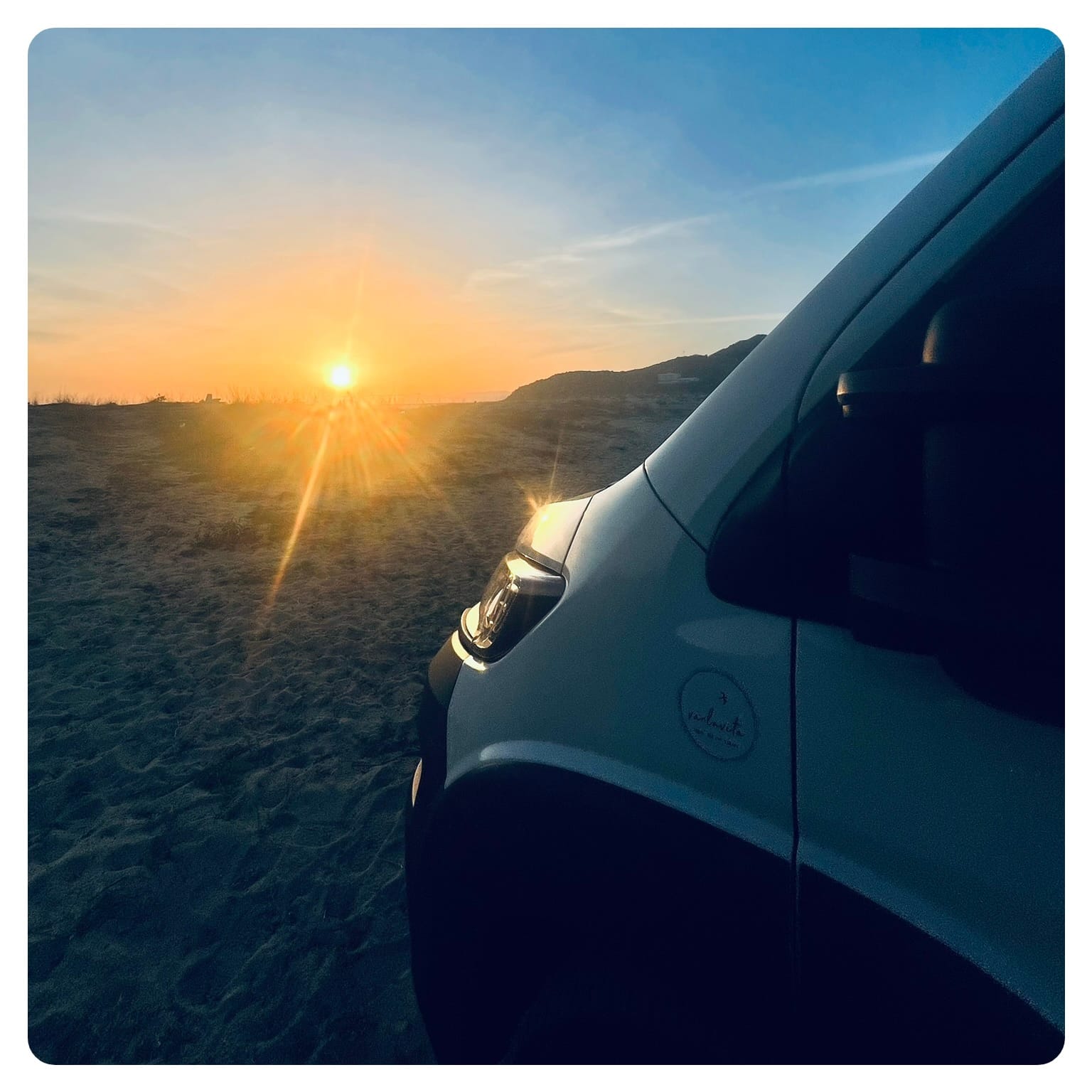 van life vanlavita camper van on beach with sunset