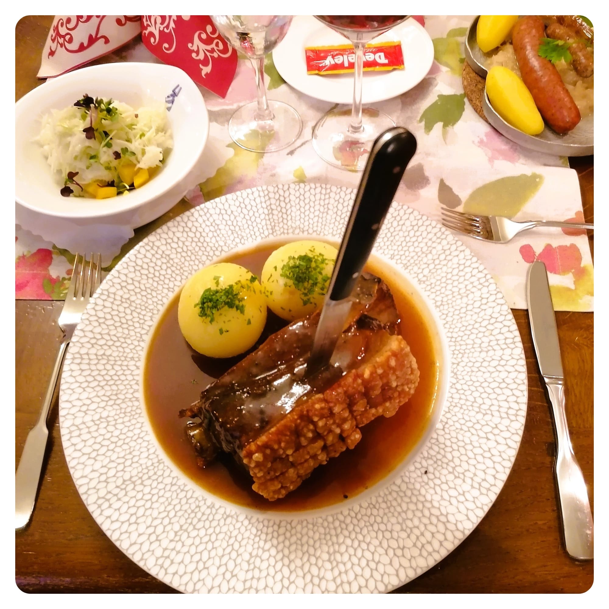 Traditional German pork dinner with gravy and potatoes served in rustic restaurant