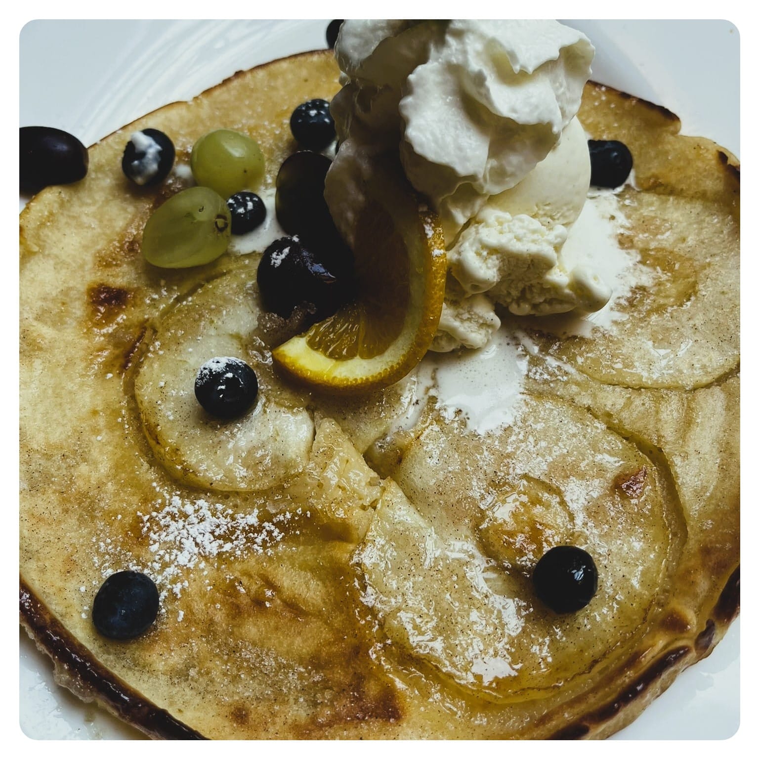 pancake topped with apples and blueberries