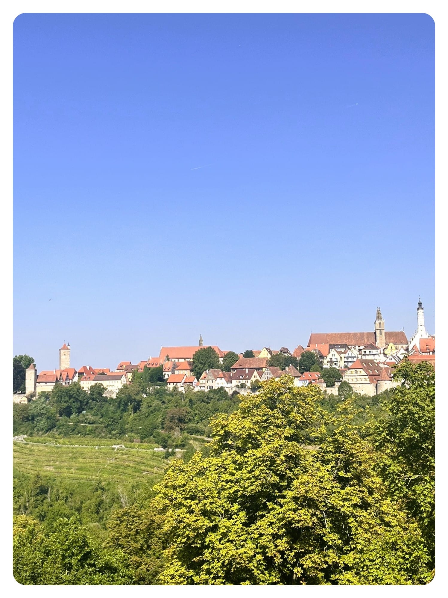 van life vanlavita view of the town with green countryside and blue sky