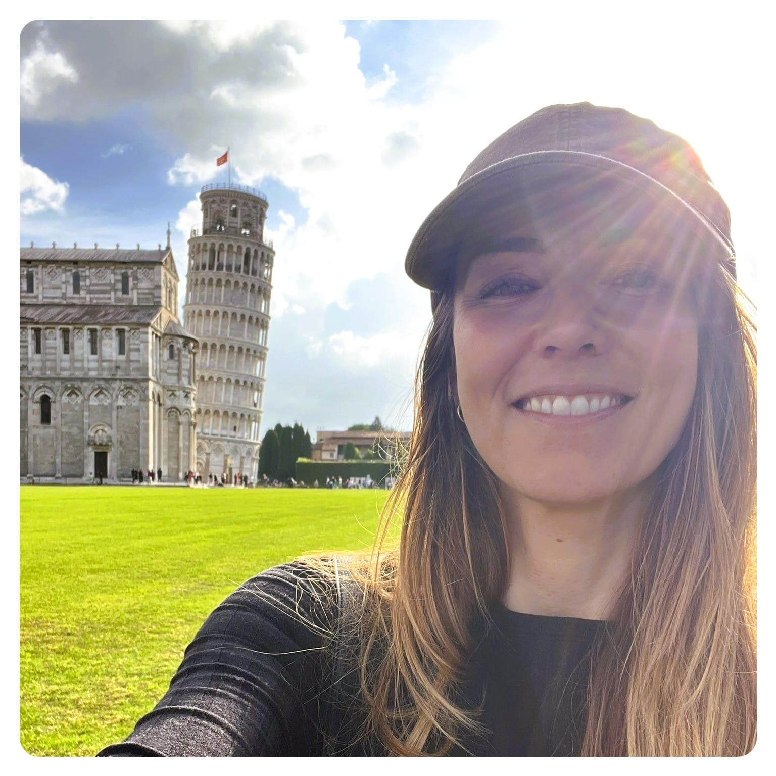 vanlife vanlavita woman stood next to the leaning town of pisa