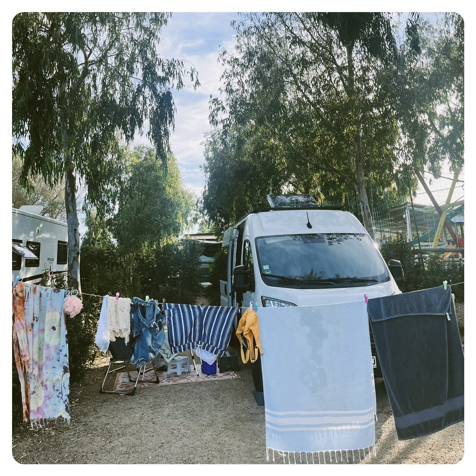 van life white van parked on campsite with washing line
