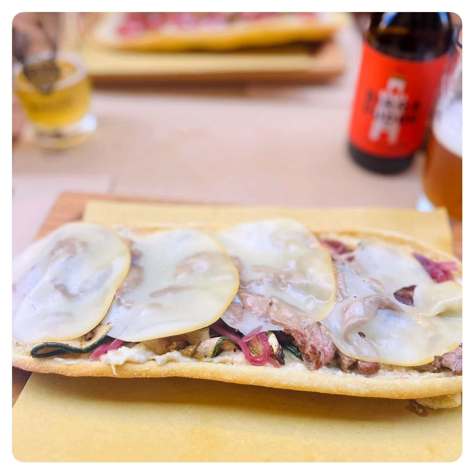 flatbread topped with steak cheese and redonions