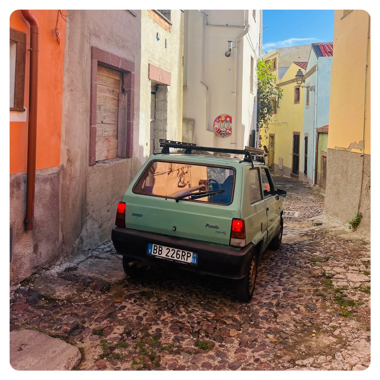Fiat Panda car driving through narrow streets in Bosa