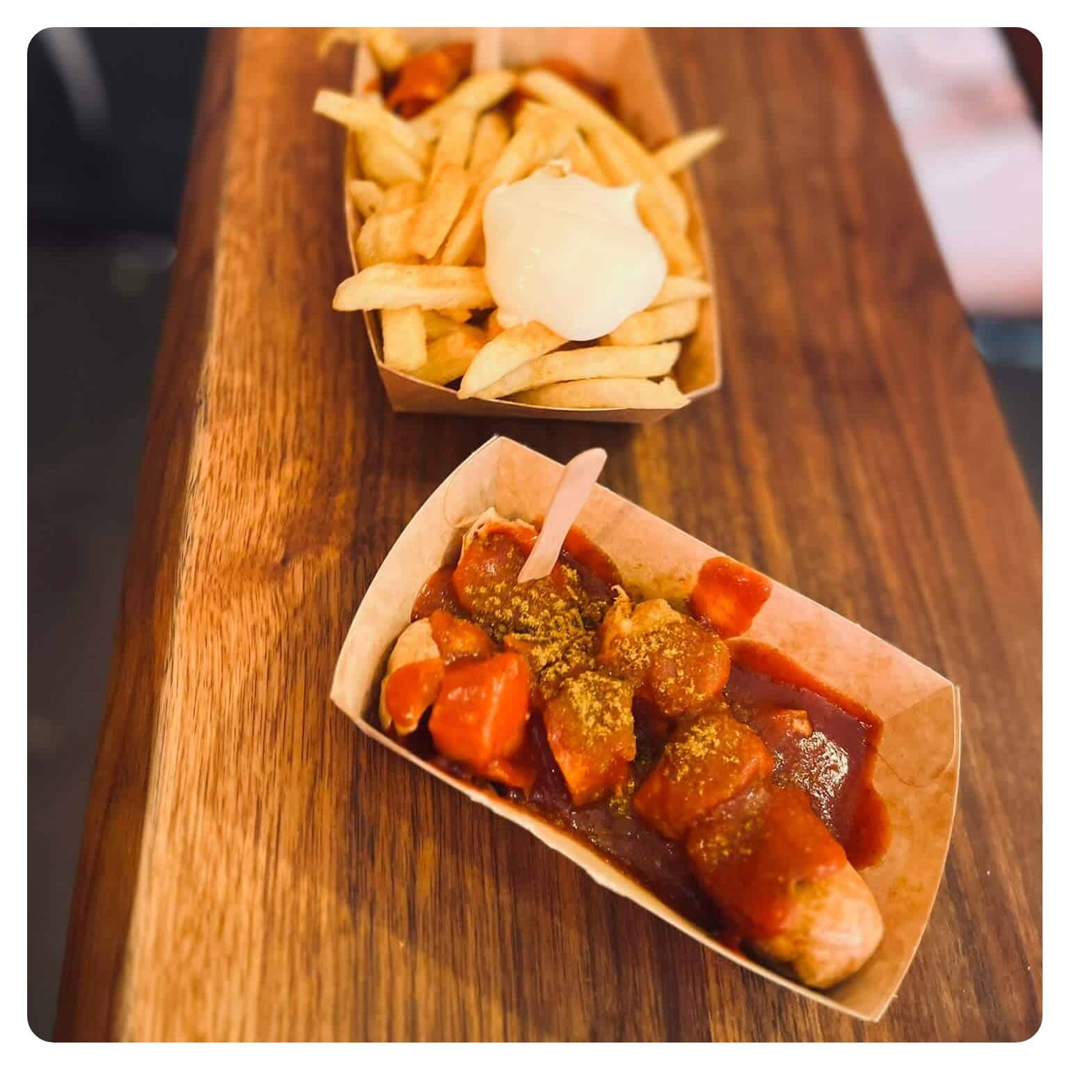German currywurst sausage with chips and mayonnaise