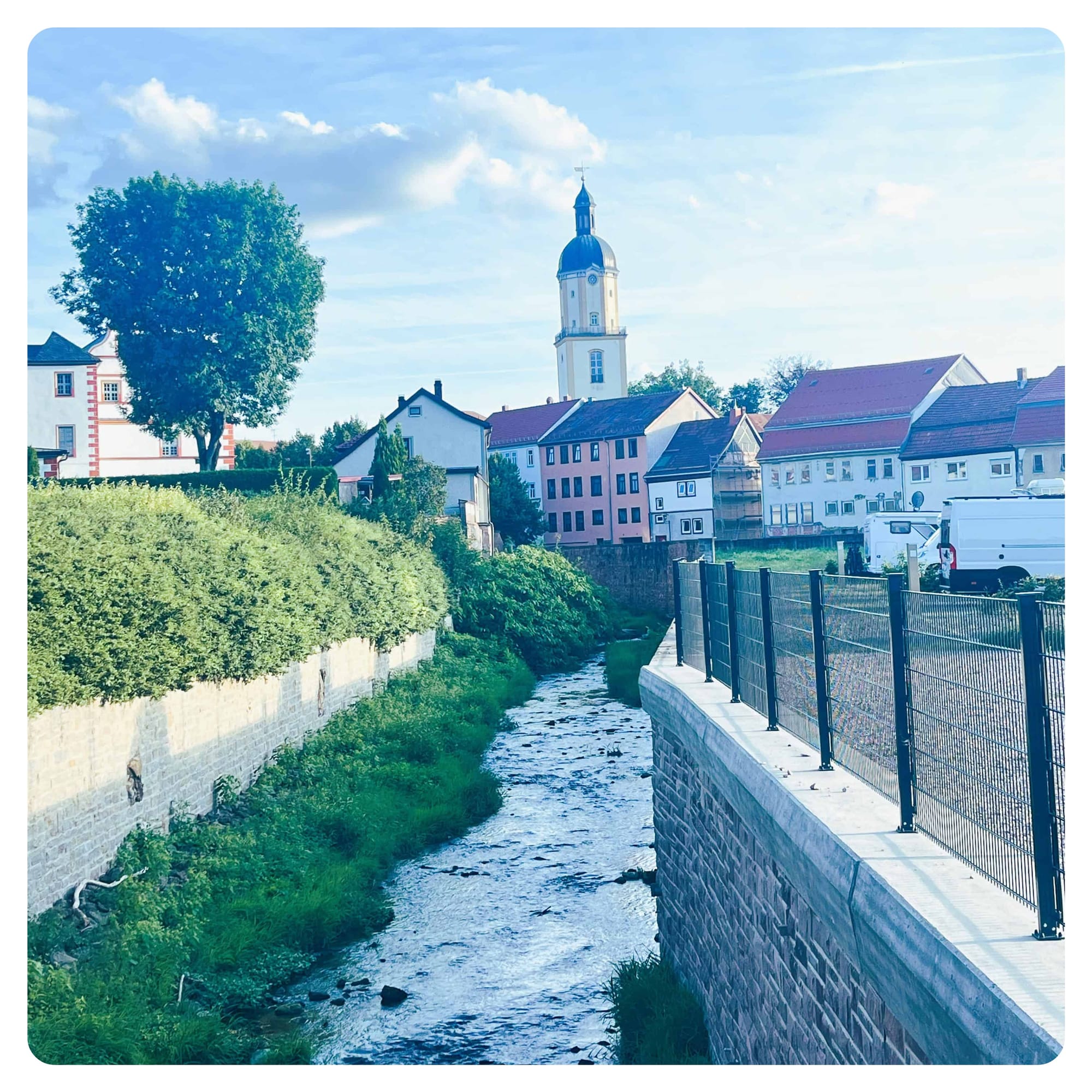 vanlife van and motorhomes parked next to stream in Ohrdruf, Germany
