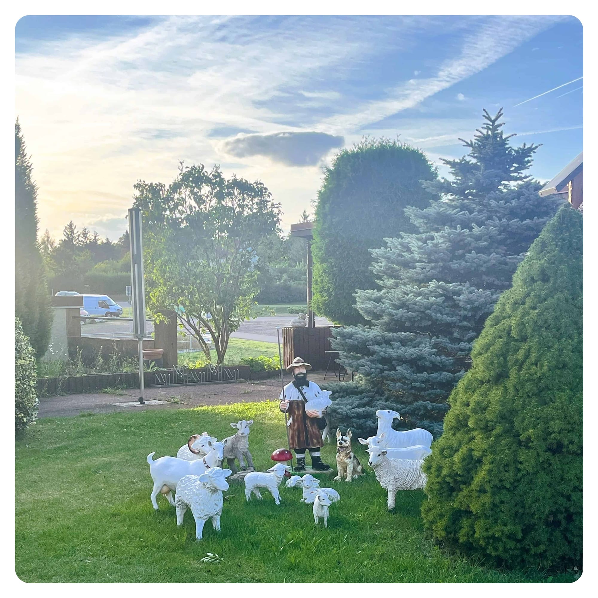 plastic garden display of shepherd with a flock of sheep and goats