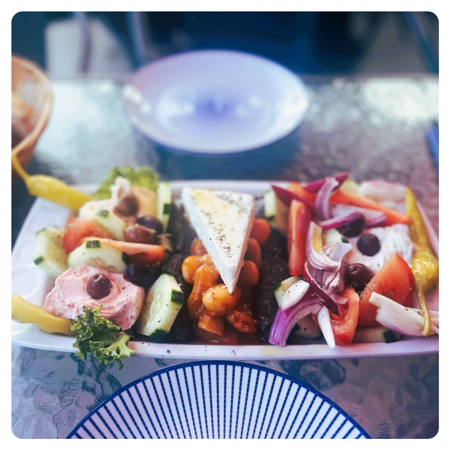 greek salad mix served on blue and white plates