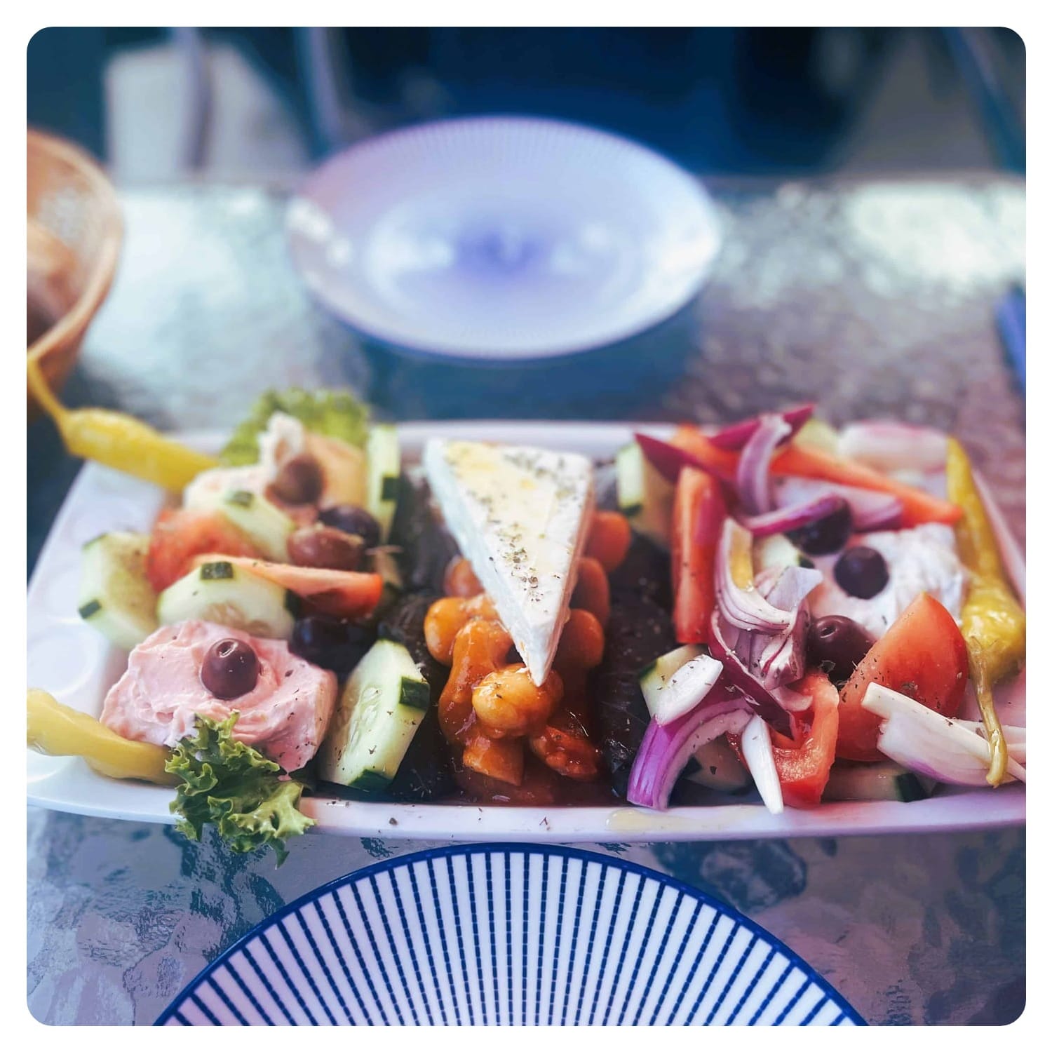 mizture of greek appetizers on blue and white porcelain plates