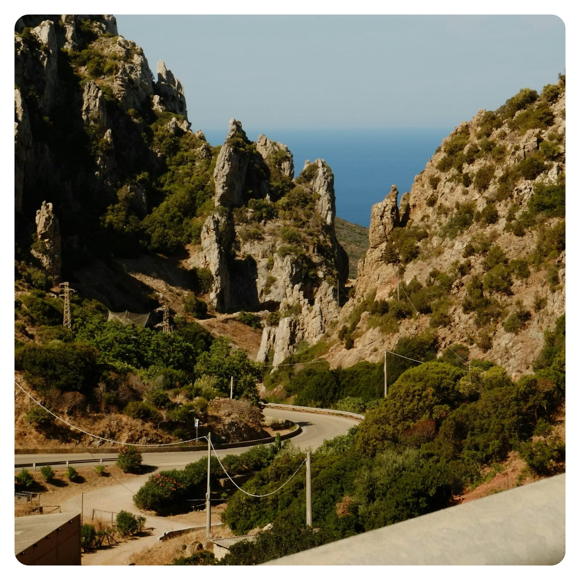 A view of a mountain with a road going through it
