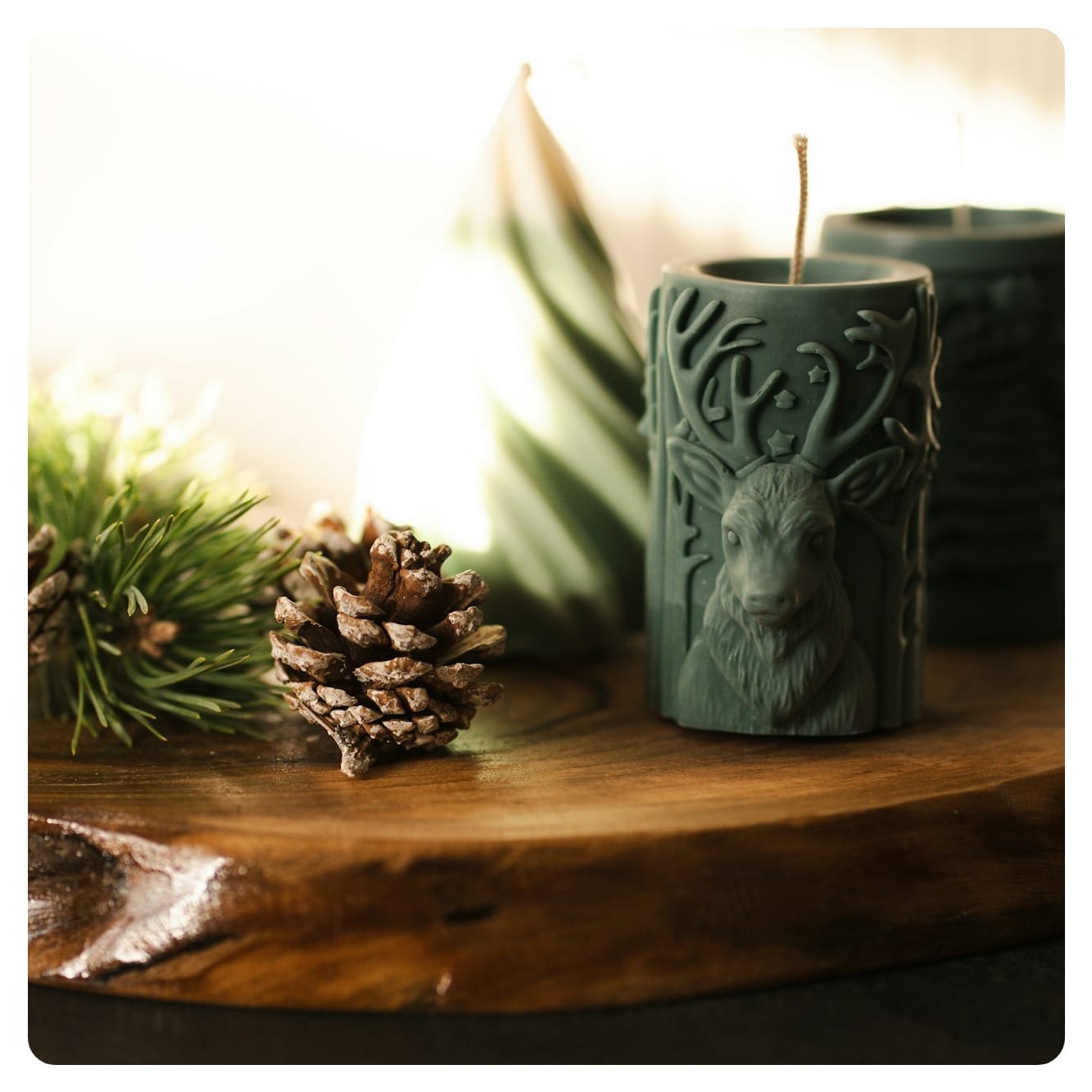 A couple of candles sitting on top of a wooden table