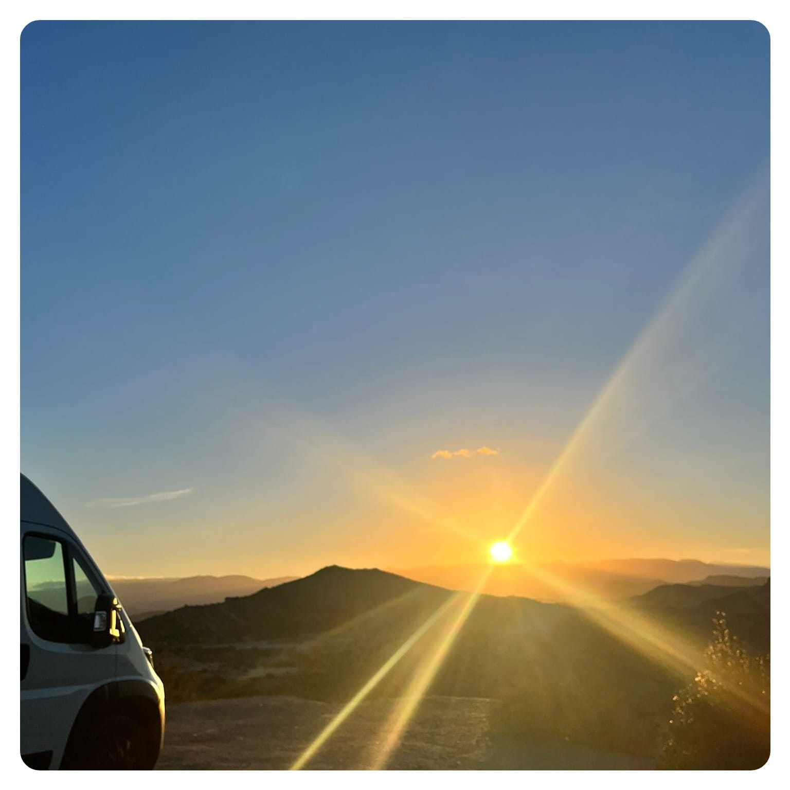 vanlavita van life overlooking mountain sunset view