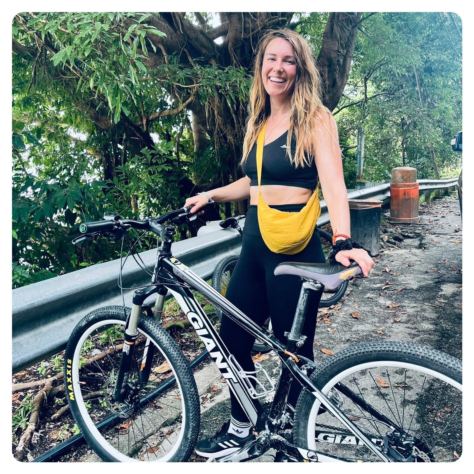 vanlavita woman stood next to black mountain bike