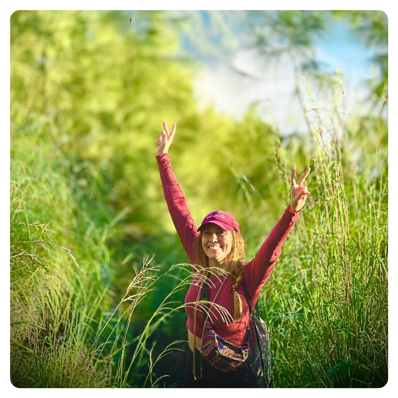 vanlavita woman in red top stoood in field of long grass