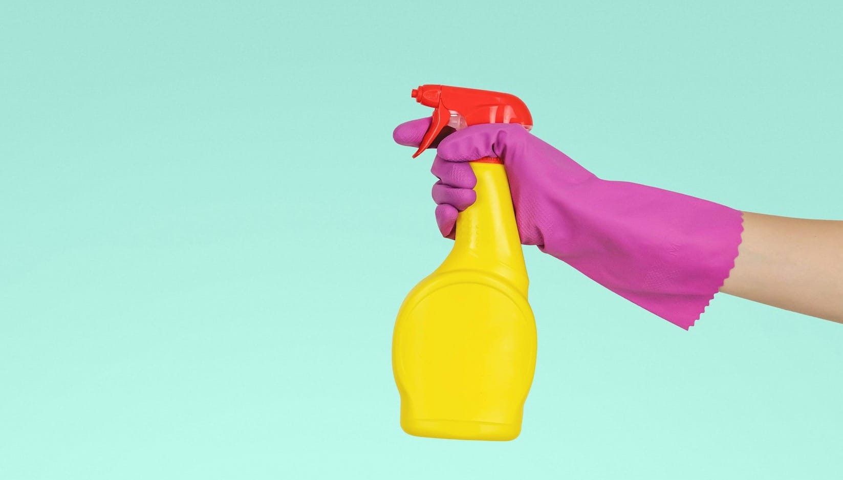 person holding yellow plastic spray bottle