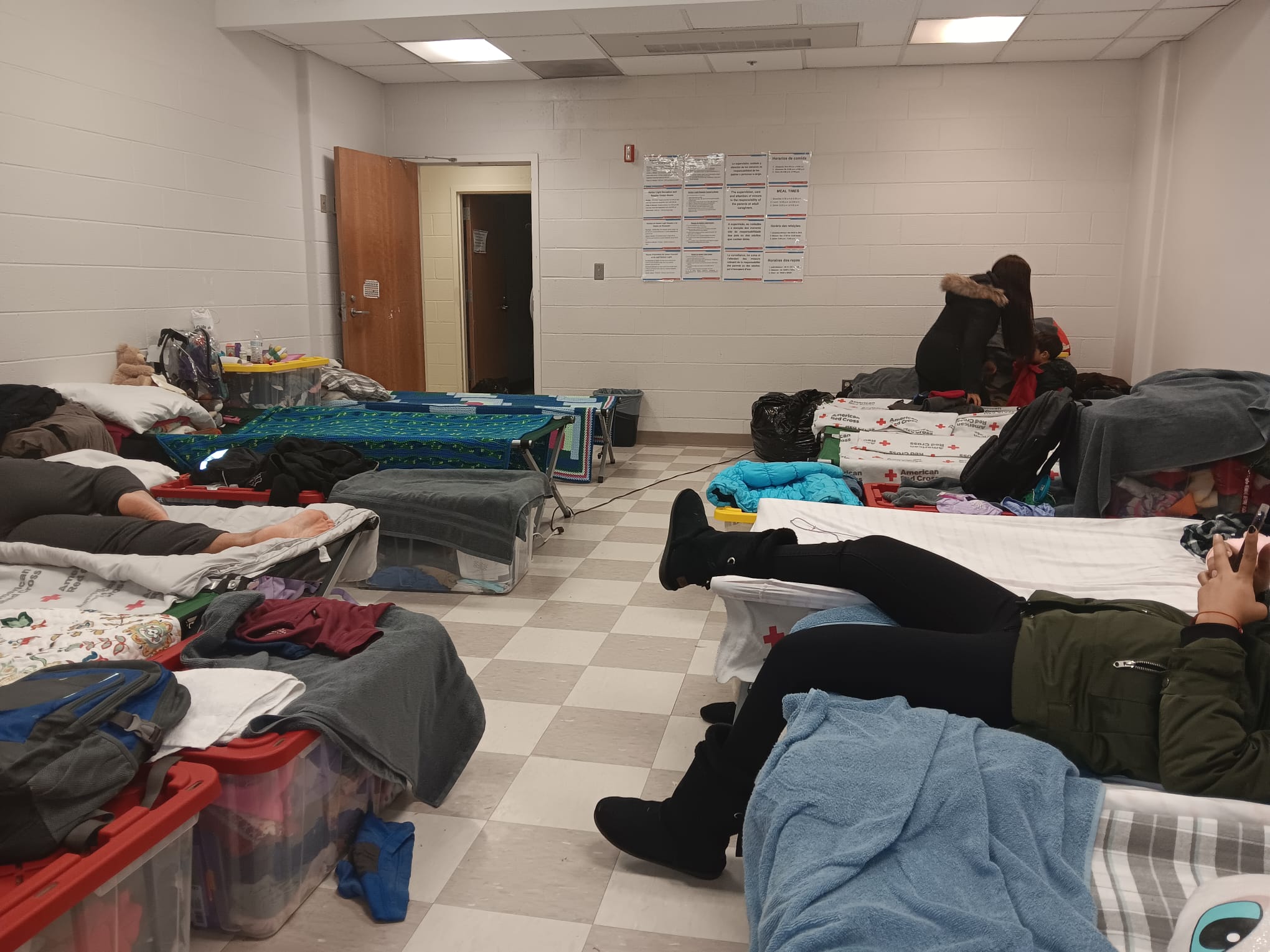 Los migrantes duermen en catres.