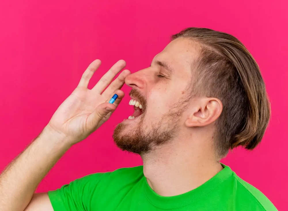 Hombre tomando píldora oral
