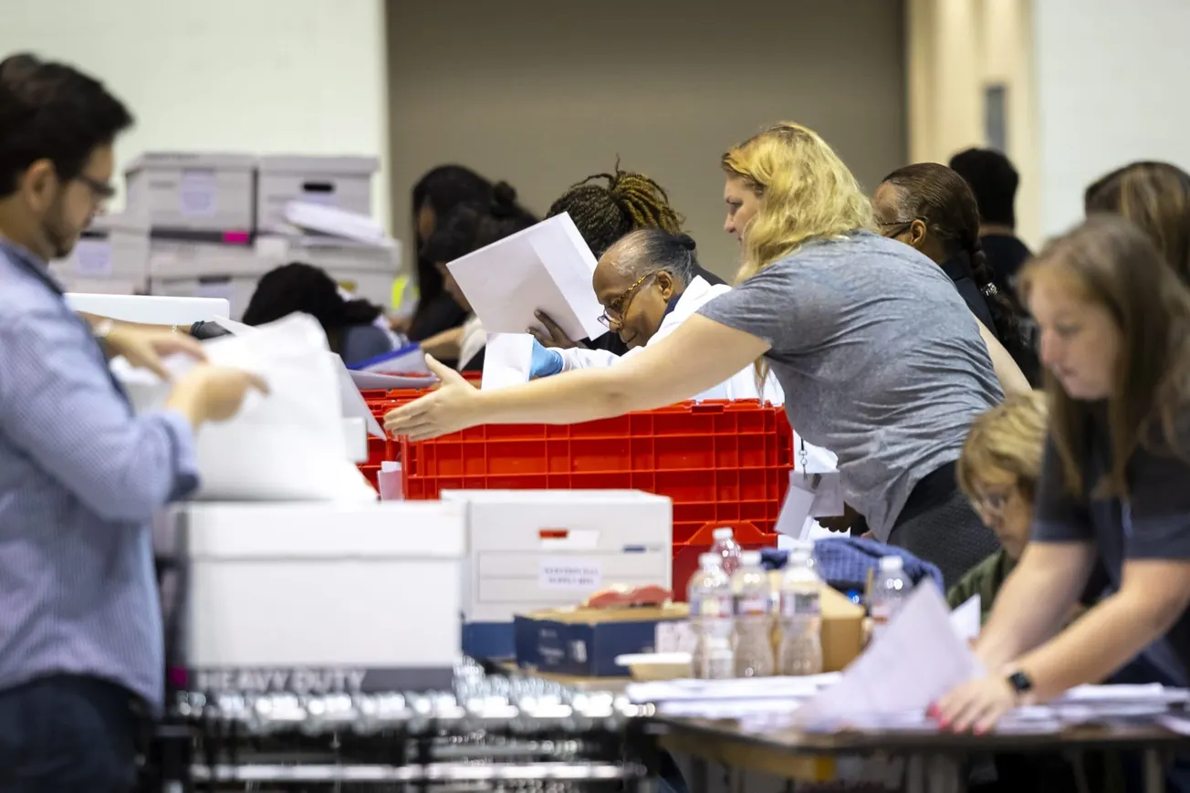 Election workers organized paperwork from each polling location at NRG Arena in Houston, Texas, on Nov. 8, 2022. (Annie Mulli