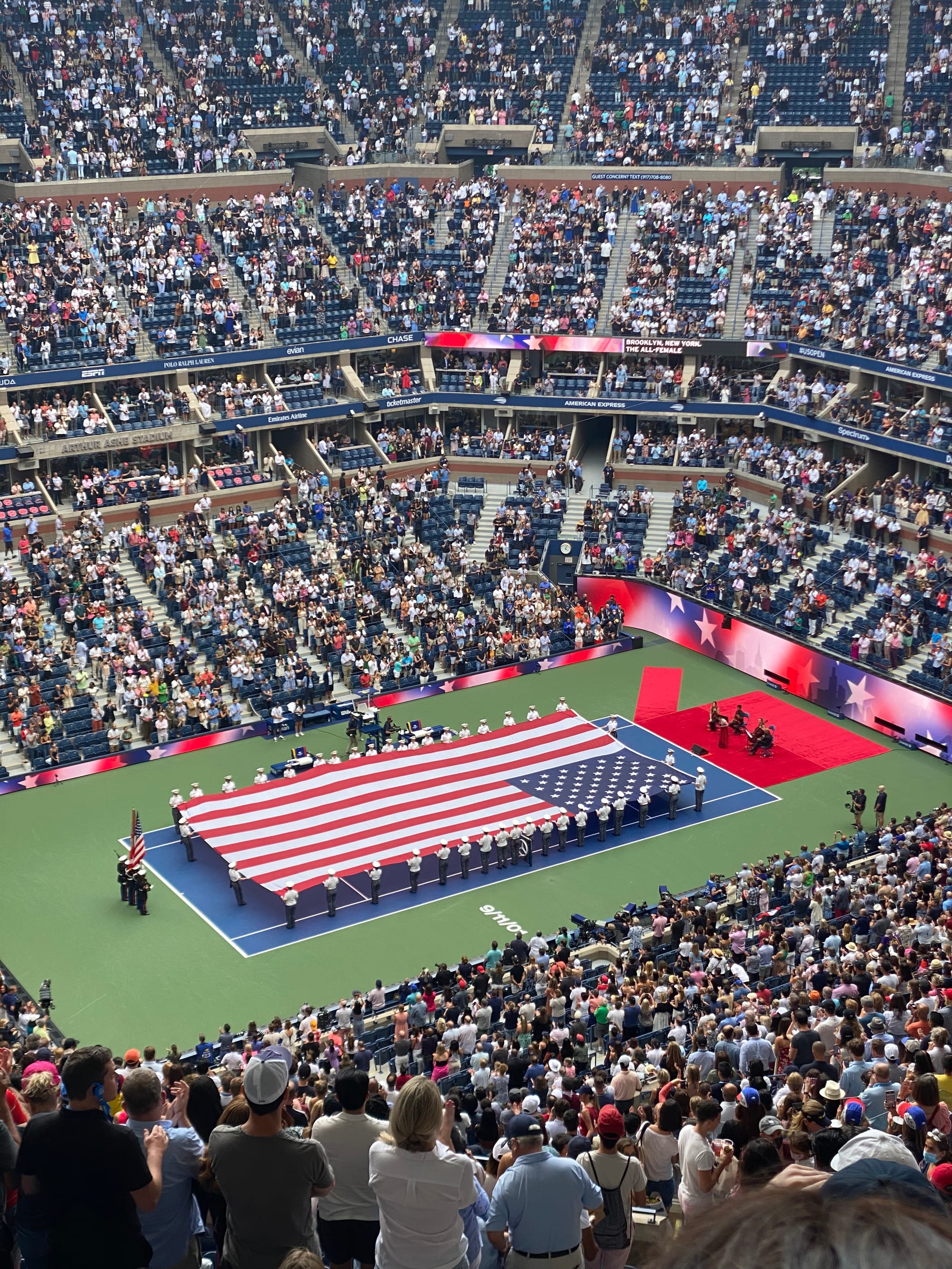 an enormous flag being held over the court at Arthur Ashe on September 11, 2021 in advance of the women's US Open final