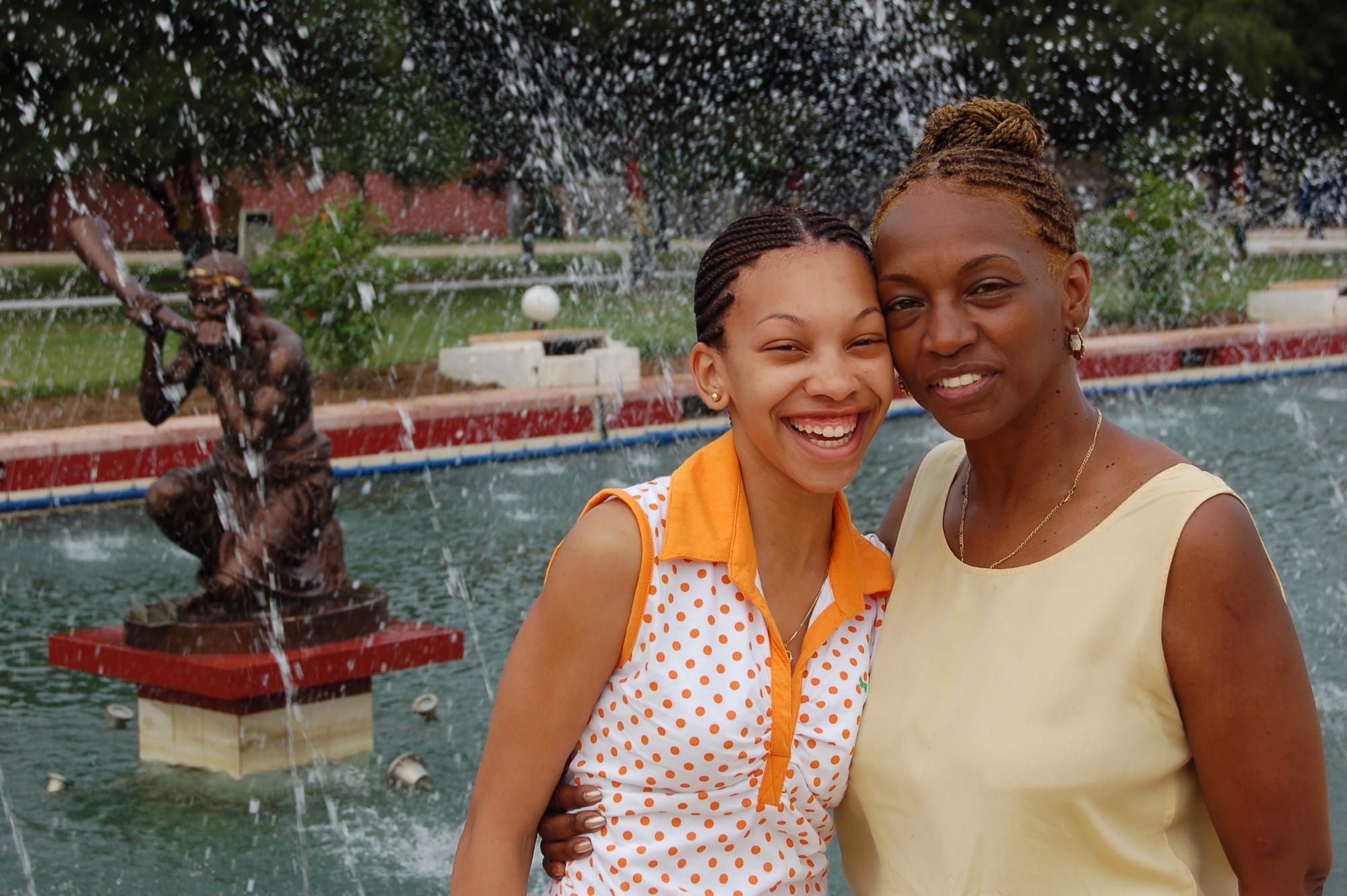 Lynai and her mother Brenda smiling together beside the fountains at Kwame Nkrumah Memorial Park in Accra, Ghana