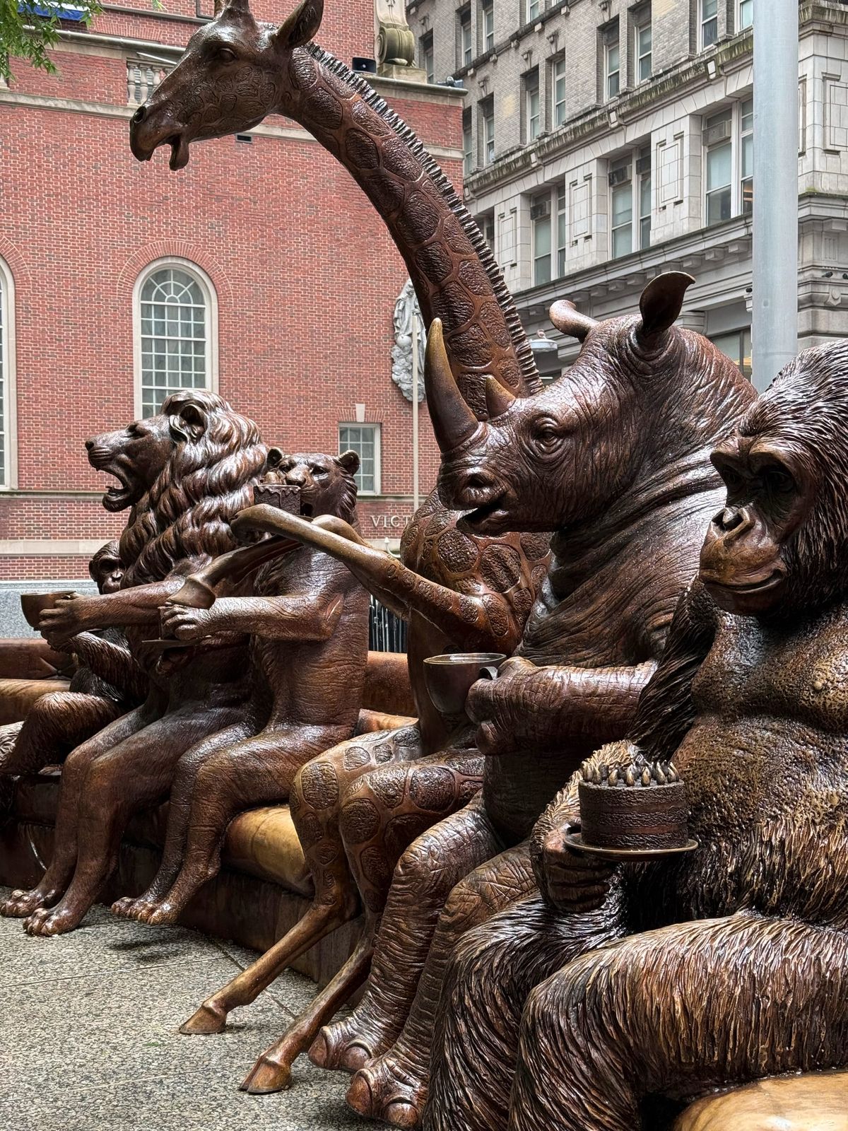 Bronze wildlife sculptures from Gillie and Marc's The Wild Couch Party installation in New York City, featuring a lion, rhino, giraffe, gorilla, and other endangered animals gathered together