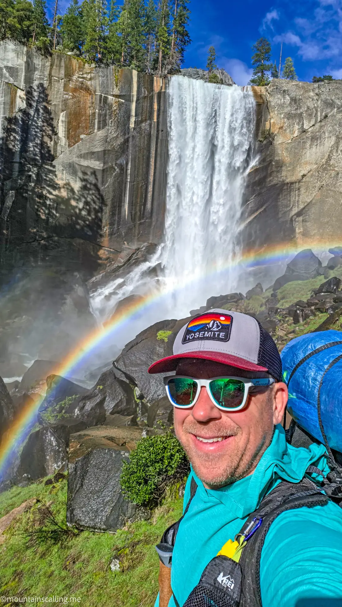 Eric Kufrin taking selfie at Vernal Fall with double rainbow in mist spray on Clouds Rest backpacking route