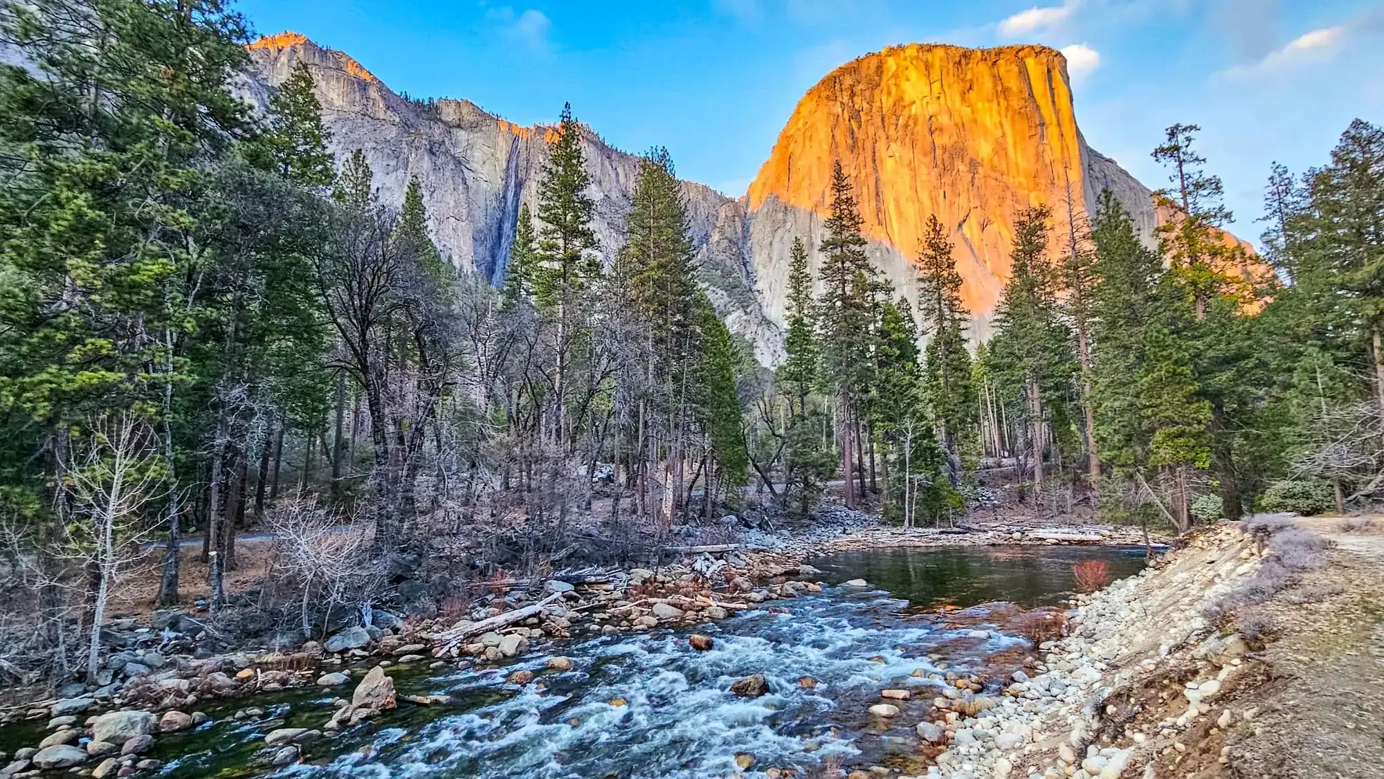 El Capitan glowing orange at sunset with Merced River flowing through Yosemite Valley on private guided day hike